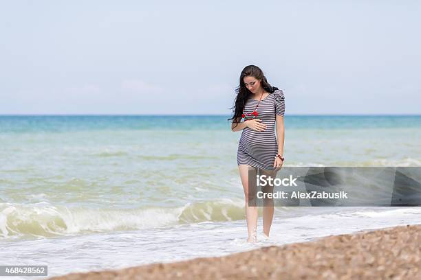 Expectant Mother On The Beach Stock Photo - Download Image Now - Pregnant, Beach, Walking