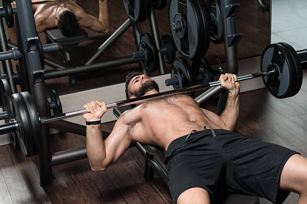 istock Young Man Exercising Chest With Barbell 468428674