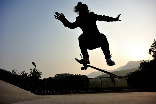 istock skateboarding jumping at sunrise 468429308