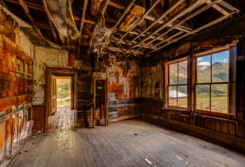 This is an interior shot of a cabin that was in the process of being restored.  The exterior view is of the Mountains.  This is an HDR image to capture as much detail as possible.