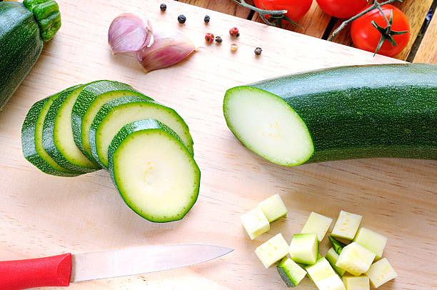 istock Green zucchini prepared on cutting board top view 468433964