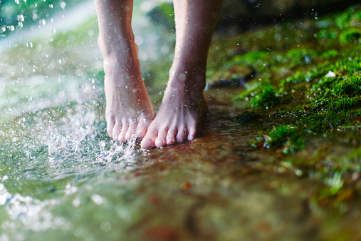 Woman walking near the waterfall