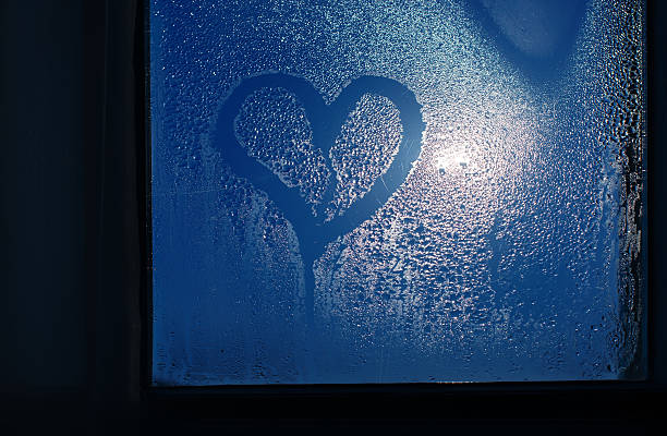 istock Moonlight through the window. Sweaty glass and heart 468435797