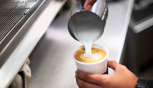 Barista making caffe latte. stock photo