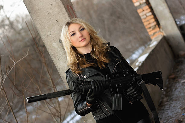 istock Beautiful young woman with a rifle 468437053