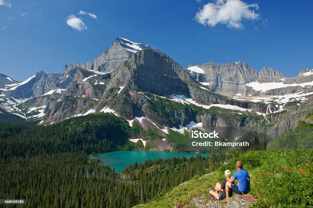 Couple enjoying the view in Glacier National Park Young Couple enjoying the view in Glacier National Park in northern Montana US Glacier National Park Stock Photo