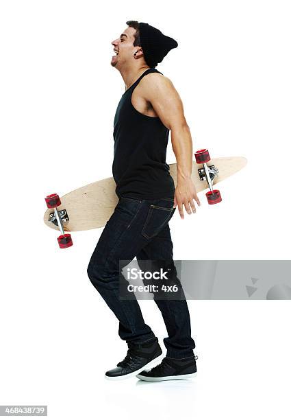 Smiling Man Walking With Skateboard Stock Photo - Download Image Now - 20-29 Years, Adult, Adults Only