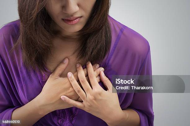 Woman Holding Chest To Indicate Heart Attack Stock Photo - Download Image Now - Women, Acute Angle, Coronary Artery