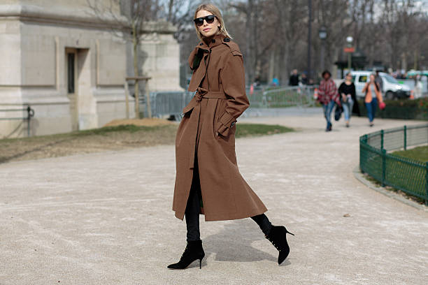 Elena Perminova before Thierry Mugler fashion show Paris, France - March 07, 2015: Elena Perminova before Thierry Mugler Fashion Show, wears an A.W.A.K.E coat, Dior sunglasses and Charlotte Olypmia boots on day 5 of Paris Fashion Week Fall Winter 15/16. street fashion stock pictures, royalty-free photos & images