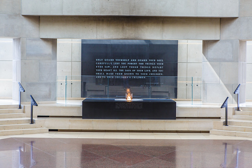 Washington, DC, USA - March 19, 2015: Eternal flame on top of block holding dirt from concentration camps in Europe in the Hall of Remembrance inside US Holocaust Memorial Museum in Washington, DC on March 19, 2015.