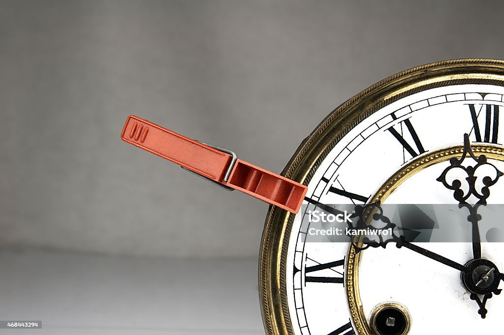 Clothespin stop the clock. Red Clothespin. Pinned to the Old Clock and stopping time. 2015 Stock Photo