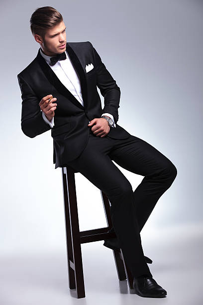 istock business man looks away while smoking on chair 468444737