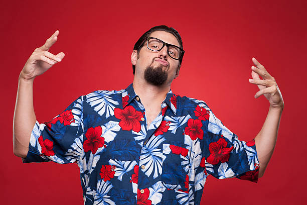 istock Young man in Hawaiian shirt posing against red background 468445991