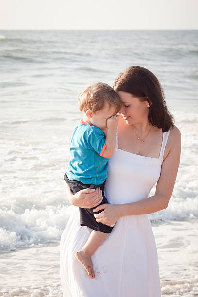 istock Young mom with son playing at the beach 468447268