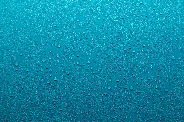 Wet surface Water drops on a blue surface blue condensation stock pictures, royalty-free photos & images