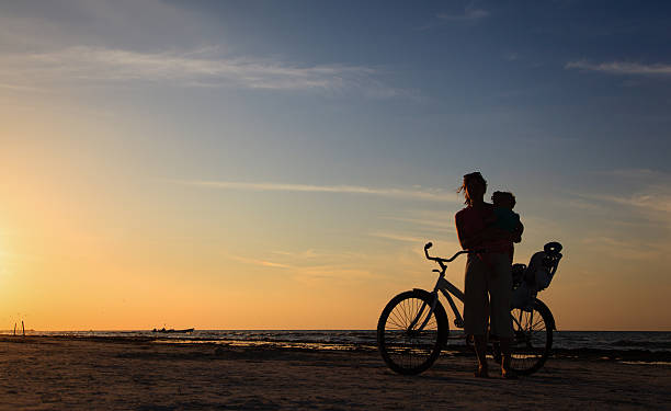 istock mother and baby biking at sunset 468448486