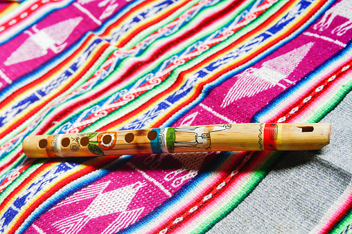wooden peruvian flute with traditional cloth
