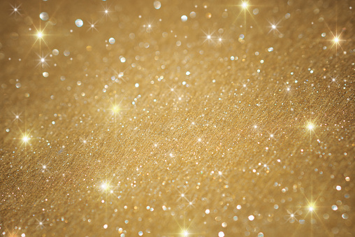 Golden glitter christmas background texture, macro shots under studio lights