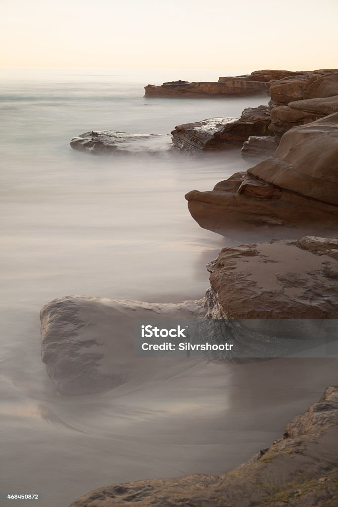 Rocky outcrop along the Pacific Ocean A long exposure turns waves into fog as they crash on the rocks along the coast of southern California.  2015 Stock Photo