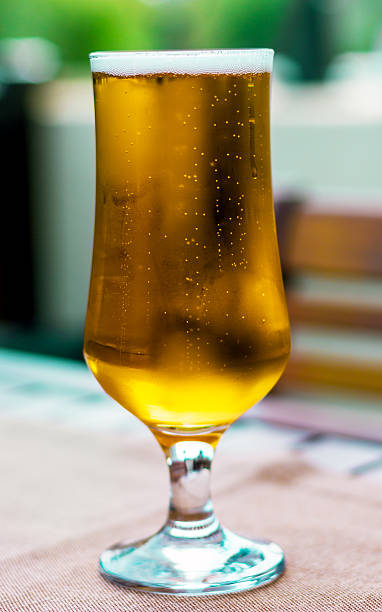 istock Glass of freshly poured beer on a table 468451311