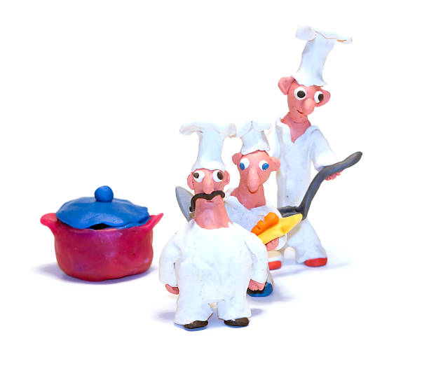 Three cheerful Food Boy made from clay cook dinner