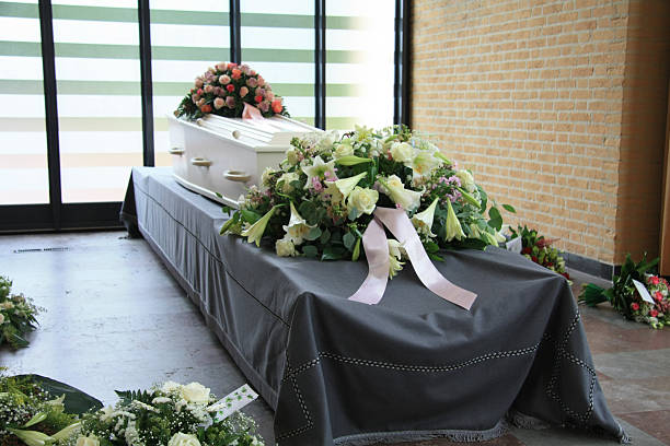 istock White coffin with pink sympathy flowers 468456473
