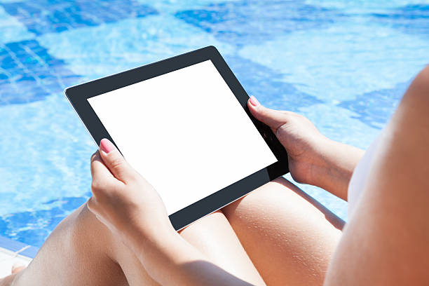 istock Woman Holding Digital Tablet At Poolside 468456934