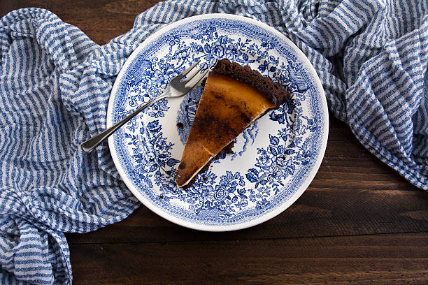 istock Cake covered in chocolate banana on blue striped tablecloth 468457346