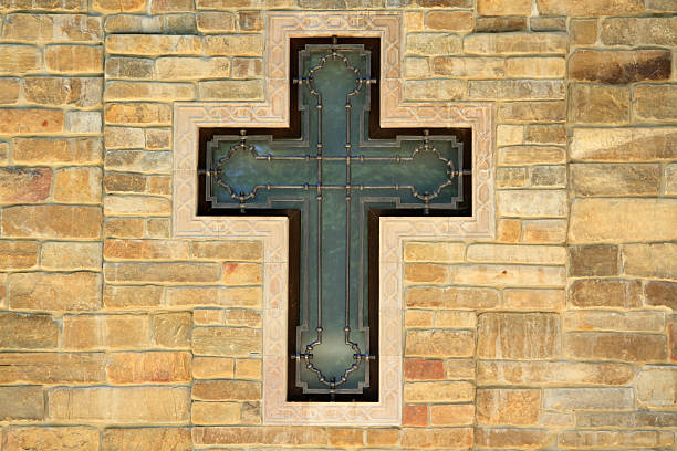 istock decorative metal cross on textured wall 468459359