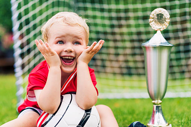 istock Little boy is really surprised after winning a trophy 468459743