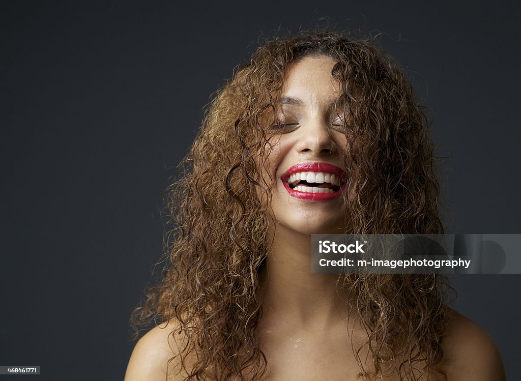 Portrait of a young african american woman laughing Close up portrait of a young african american woman laughing Wet Hair Stock Photo