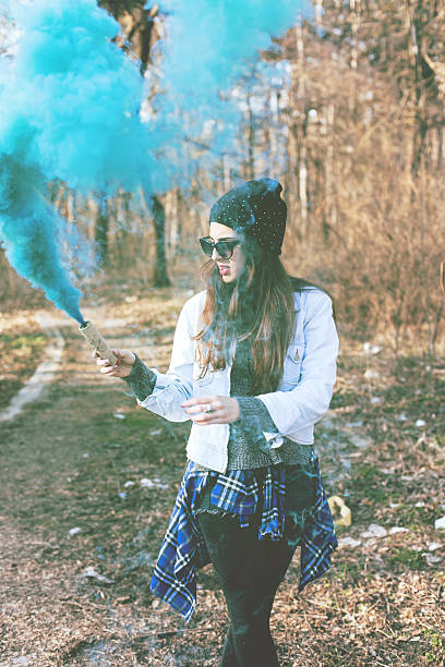 istock Hipster girls holding blue smoke 468464584