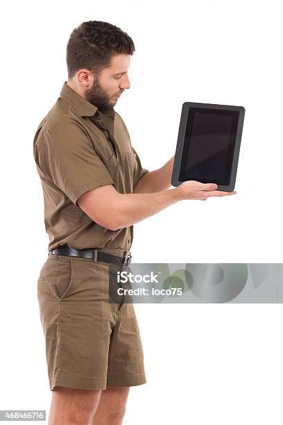 Man In Khaki Uniform Showing A Shockproof Digital Tablet Stock Photo - Download Image Now