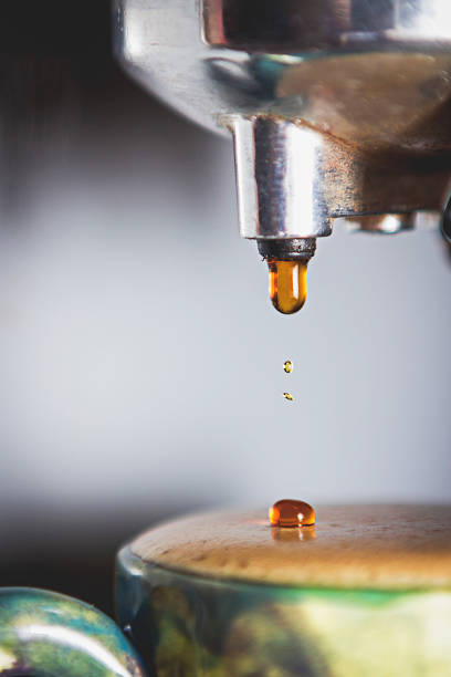 Espresso dripping out of portafilter into a cup