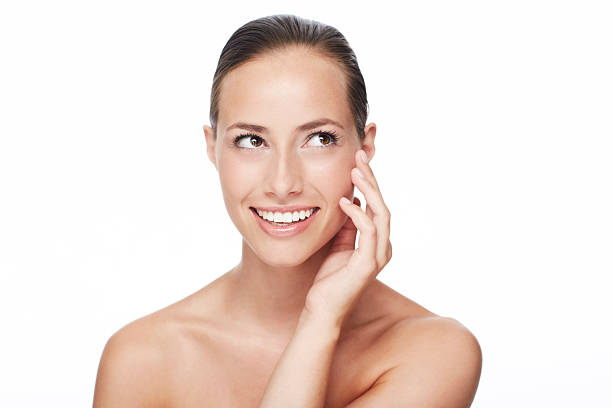 istock Young woman smiling in studio, looking up 468468469