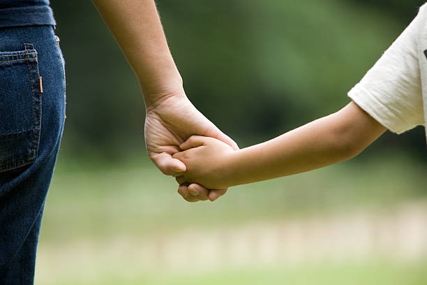 istock mother and son holding hands 468468733