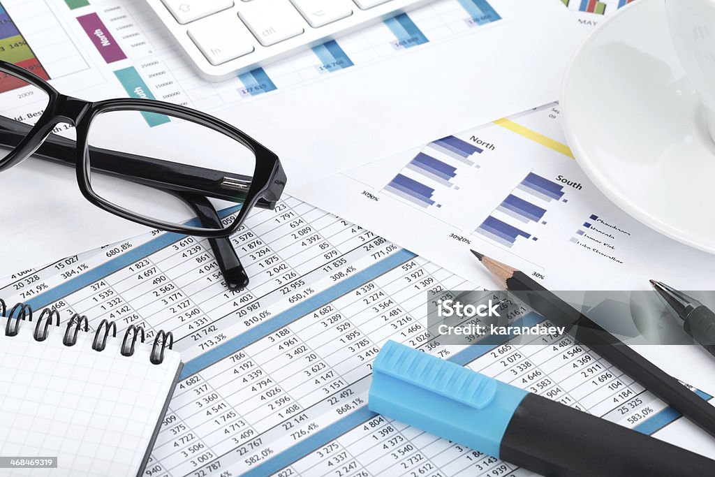 Contemporary workplace Contemporary workplace closeup with financial papers and office supplies Balance Stock Photo