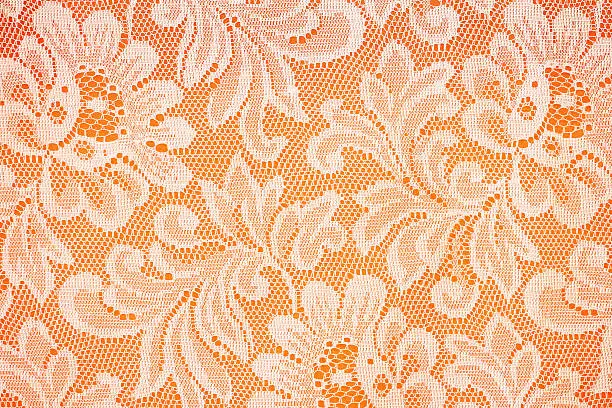 Photo of Peach lace sits on a oreng background