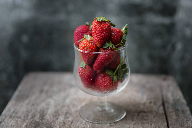istock stawberry in glass on wooden table 468472032