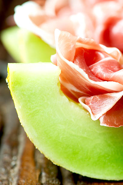 istock Serrano ham with melon on old wooden table vertical 468473737