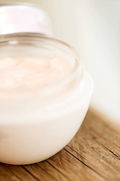 istock Cosmetic cream in jar close up on wooden surface 468475461