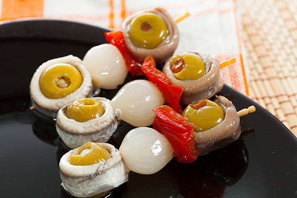 Spanish typical cover Spanish cover of boqueron, anchovies, olives, peppers and onions banderilla stock pictures, royalty-free photos & images