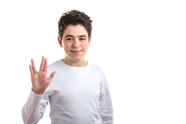 Vulcan salute by Caucasian smooth-skinned boy Caucasian smooth-skinned boy in a white long sleeved t-shirt makes vulcan salute vulcan salute stock pictures, royalty-free photos & images