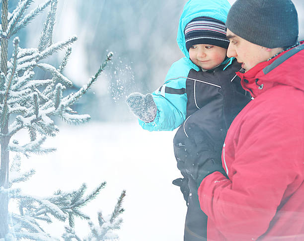istock Father walks with son in winter nature 468479320