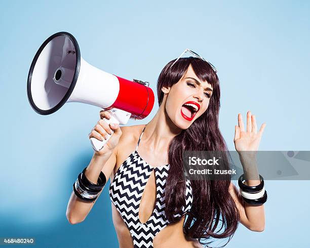 Excited Young Woman Wearing Swimsuit Screaming Into Magaphone Stock Photo - Download Image Now