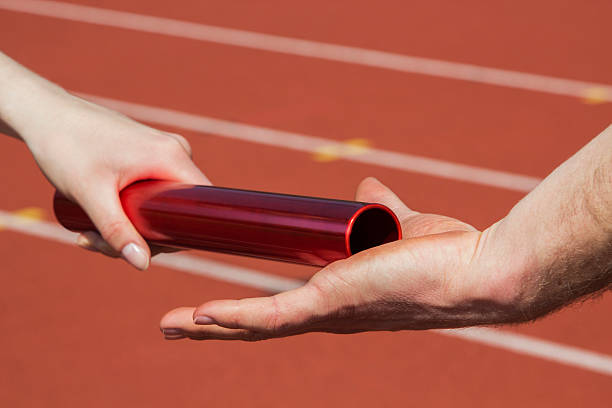 istock Relay race handing over 468483462
