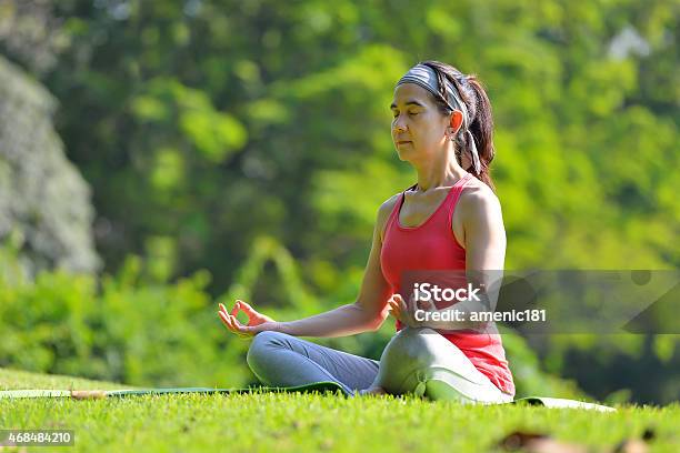 Woman Practicing Yoga Stock Photo - Download Image Now - 2015, 50-59 Years, Adult