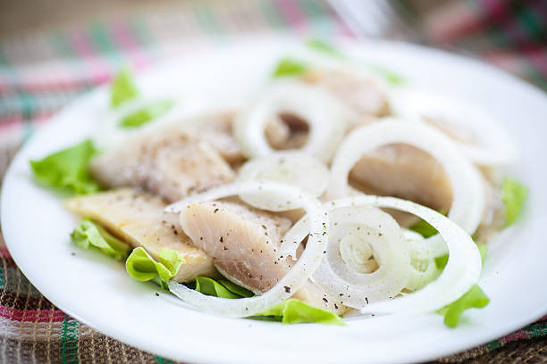 istock pieces of salted herring with onions 468487344