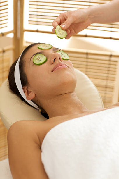istock woman  on massage table with cucumber slice pla 468487808