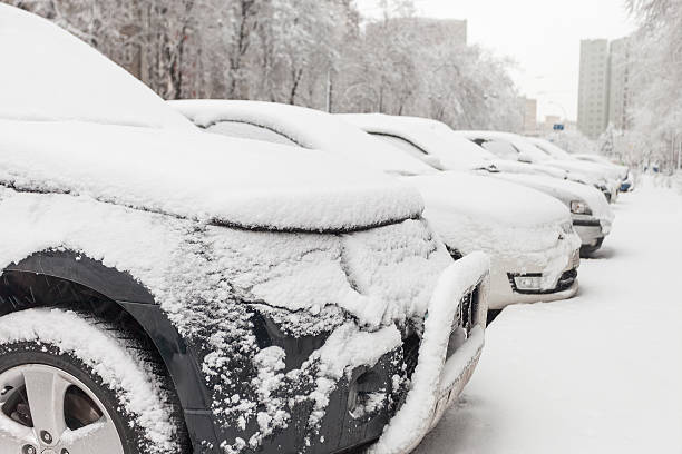 istock vehicles covered with snow  blizzard in the parking lot 468489102